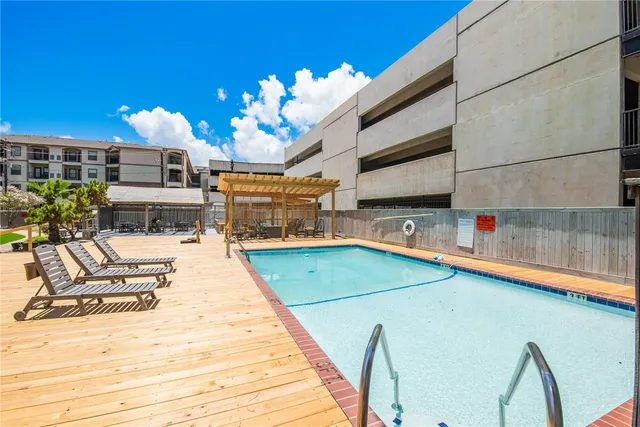a swimming pool with outdoor seating and yard