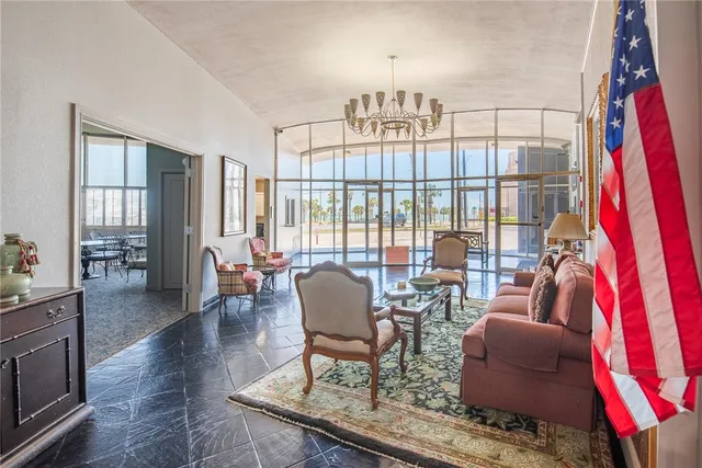 a living room with fireplace furniture and a chandelier