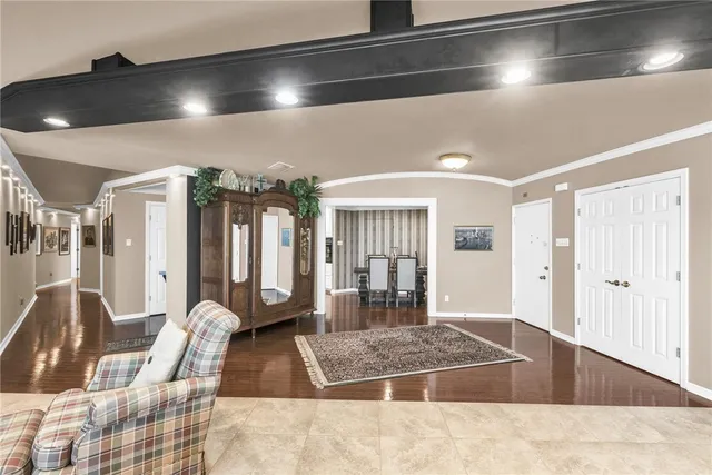 a living room with lots of furniture and a large window