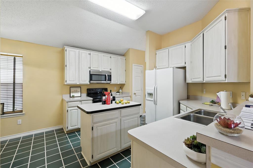 4609 Hunters Ridge Drive Sachse, TX 75048 - Photo 11 of 38 a kitchen with a sink a stove and refrigerator