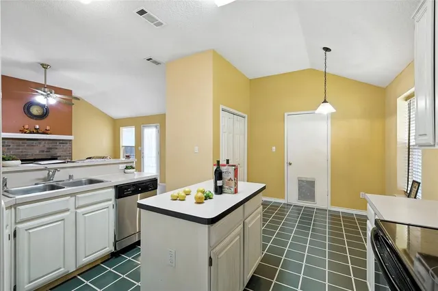 a kitchen with a sink cabinets and appliances