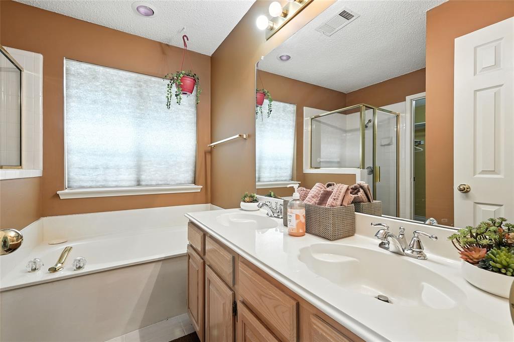 4609 Hunters Ridge Drive Sachse, TX 75048 - Photo 20 of 38 a bathroom with a tub a sink and a large mirror