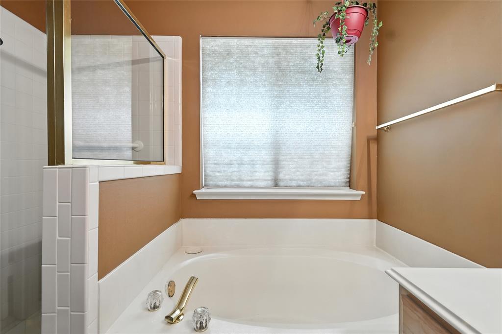 4609 Hunters Ridge Drive Sachse, TX 75048 - Photo 22 of 38 a white bath tub sitting next to a window