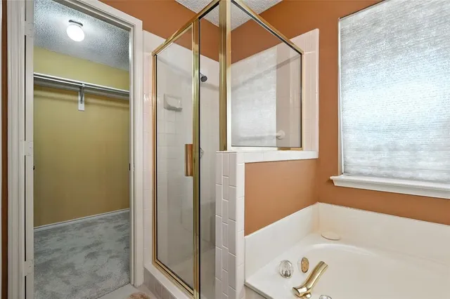 a bathroom with a bathtub and a shower