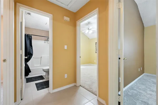 a view of a bathroom from a hallway