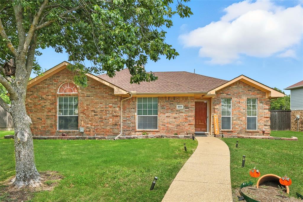 4609 Hunters Ridge Drive Sachse, TX 75048 - Photo 35 of 38 a front view of a house with a yard