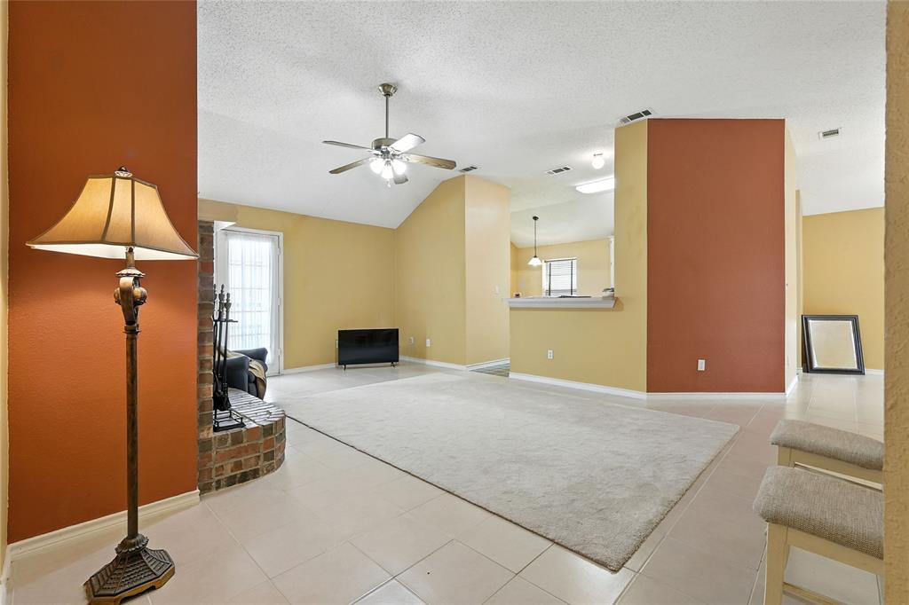 4609 Hunters Ridge Drive Sachse, TX 75048 - Photo 4 of 38 a bedroom with a bed and a chandelier