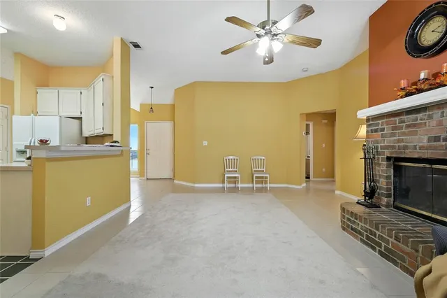 a view of a kitchen with a sink and a fireplace