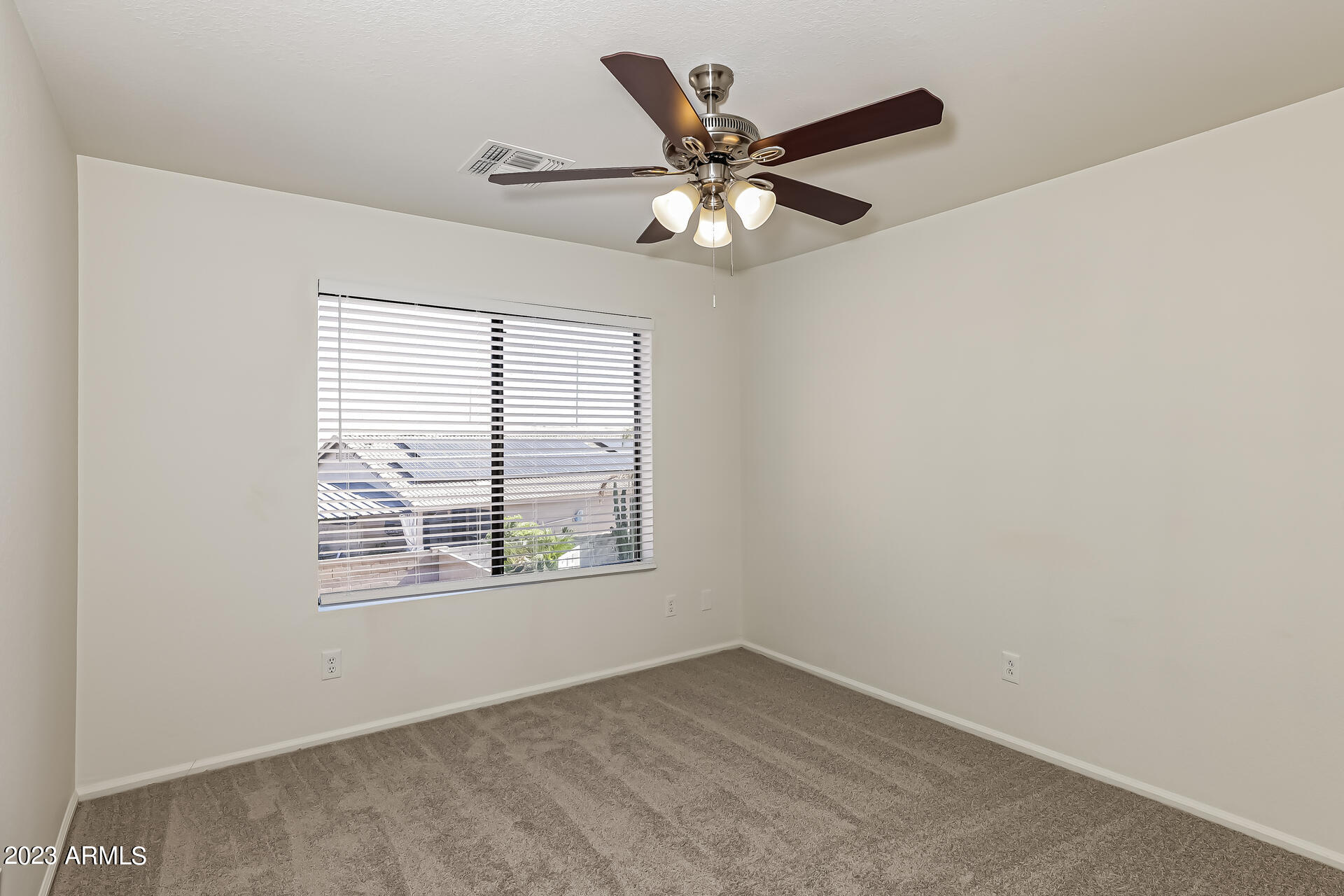 20247 North 34th Street Phoenix, AZ 85050 - Photo 12 of 17 an empty room with wooden floor fan and windows