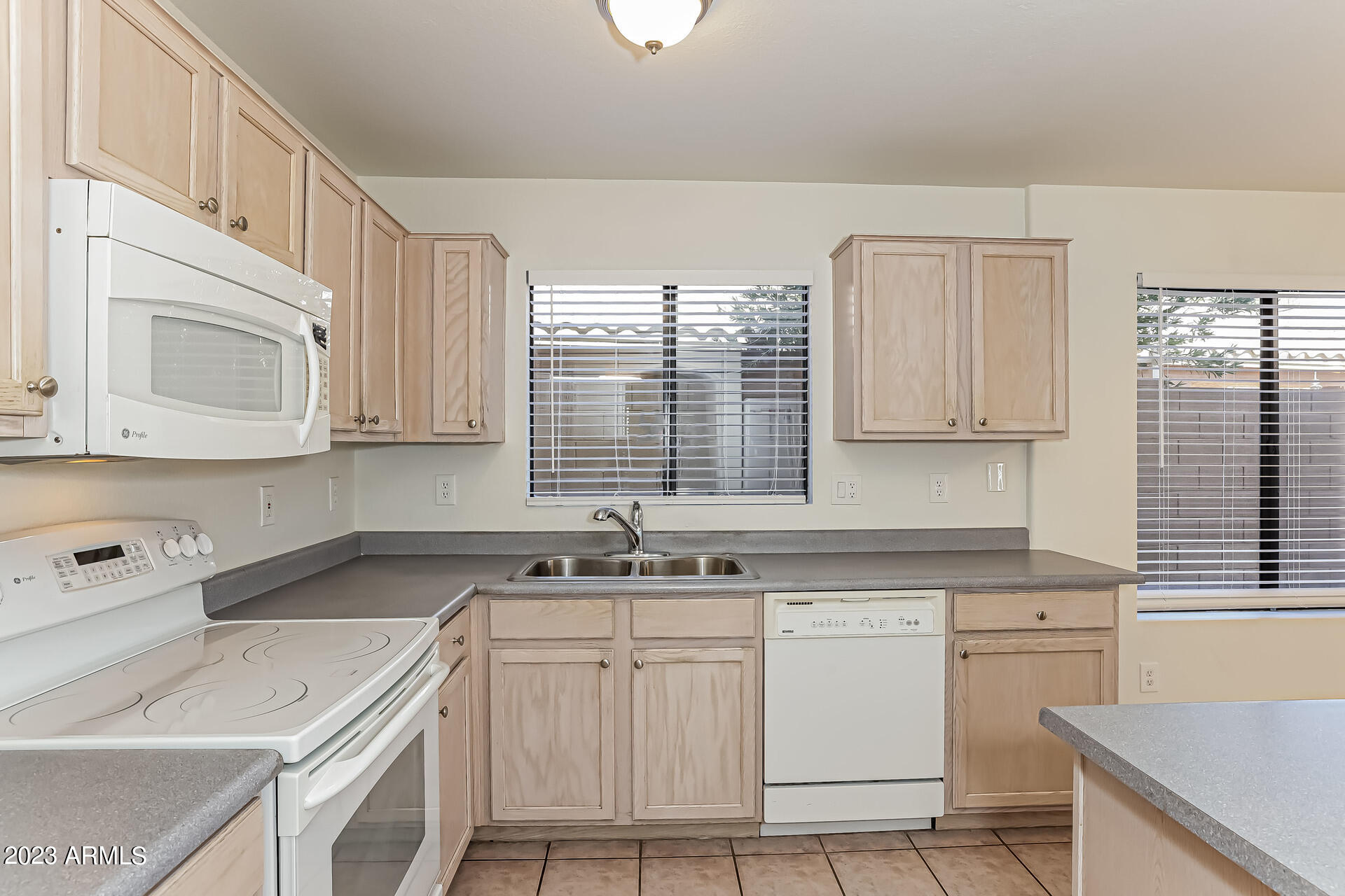 20247 North 34th Street Phoenix, AZ 85050 - Photo 4 of 17 a kitchen with a sink stove and cabinets