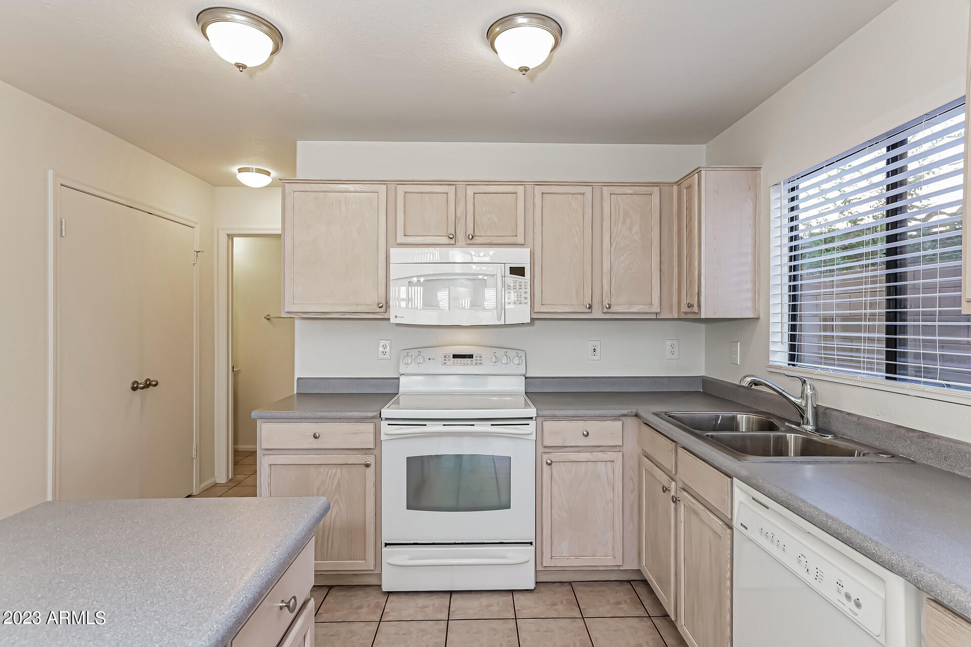 20247 North 34th Street Phoenix, AZ 85050 - Photo 5 of 17 a kitchen with a stove cabinets and a sink