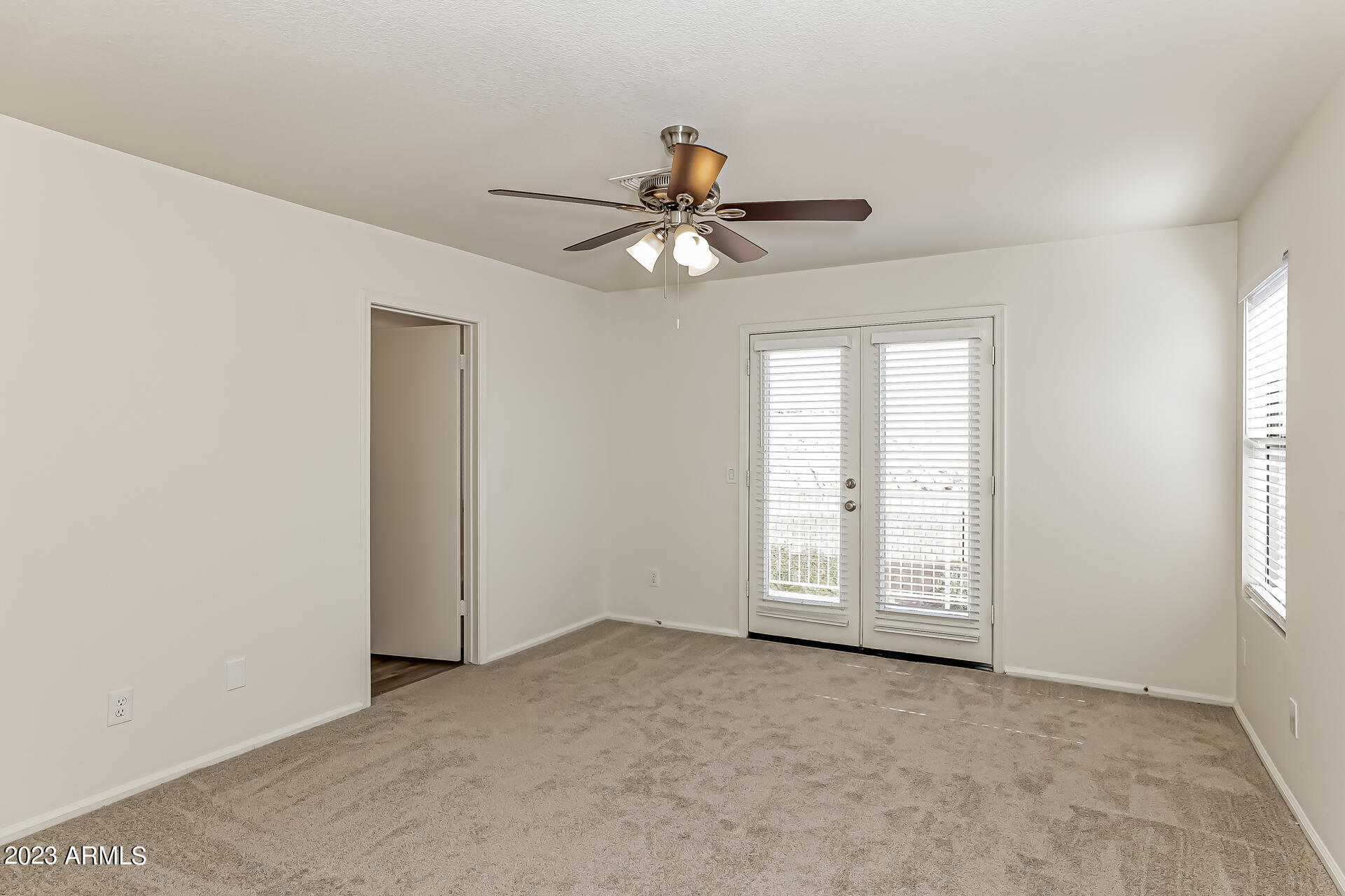 20247 North 34th Street Phoenix, AZ 85050 - Photo 7 of 17 an empty room with windows and fan