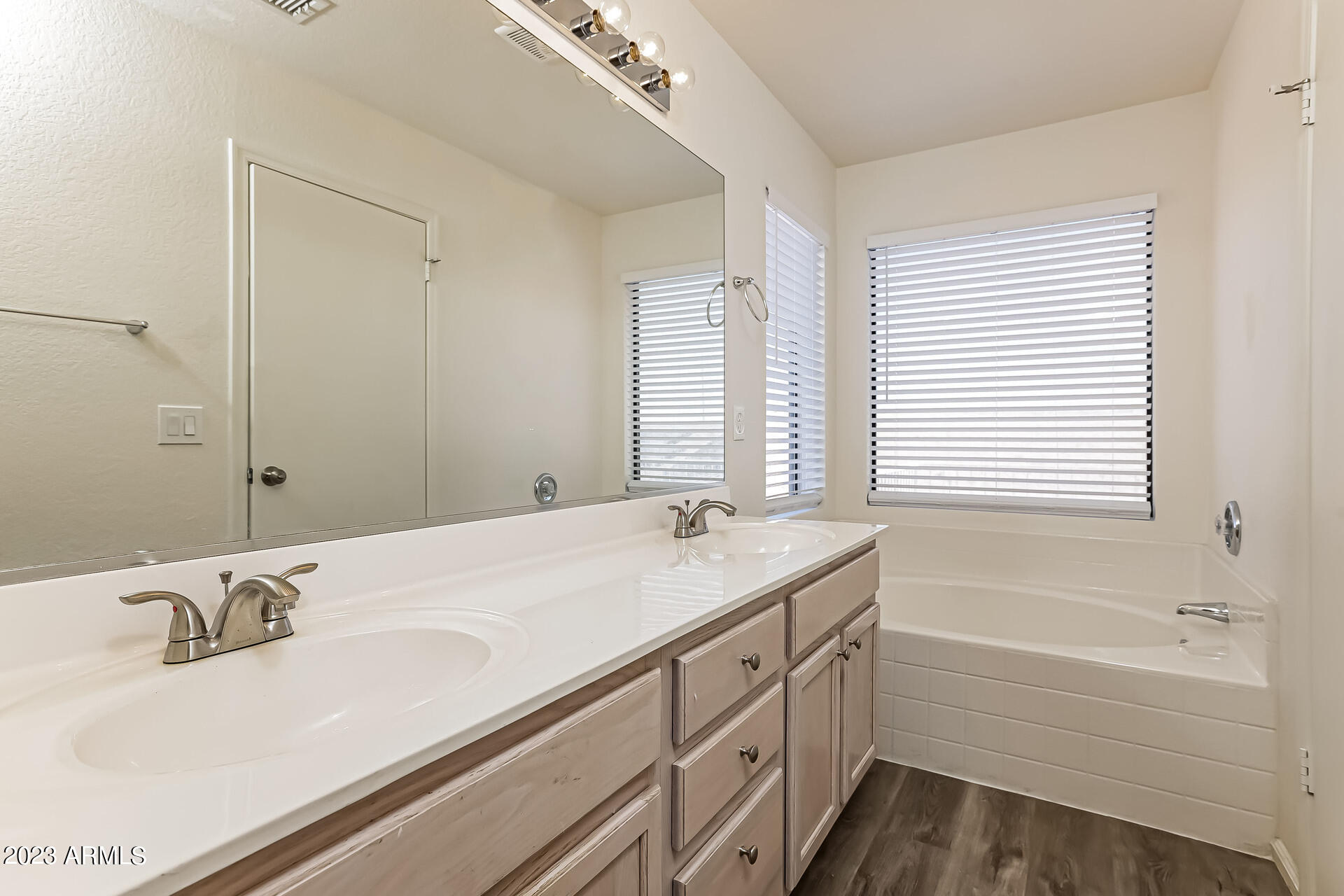 20247 North 34th Street Phoenix, AZ 85050 - Photo 8 of 17 a bathroom with a granite countertop sink and a bathtub
