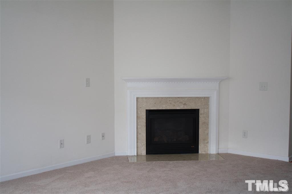 114 Graystar Road Apex, NC 27502 - Photo 2 of 8 Oversized living room has numerous seating area arrangements with corner gas log fireplace.