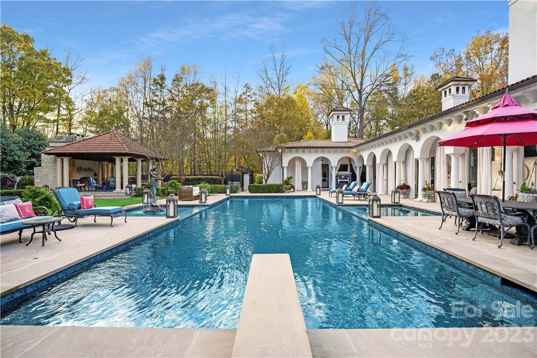 8371 Providence Road Charlotte, NC 28277 - Photo 11 of 48 a view of a swimming pool with a patio and a yard