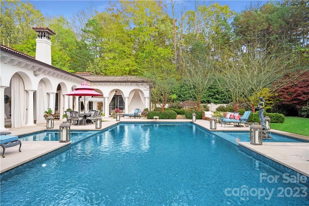8371 Providence Road Charlotte, NC 28277 - Photo 12 of 48 a swimming pool with outdoor seating and yard
