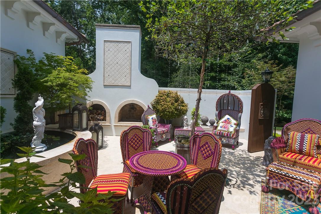 8371 Providence Road Charlotte, NC 28277 - Photo 26 of 48 a backyard of a house with fire pit and outdoor seating