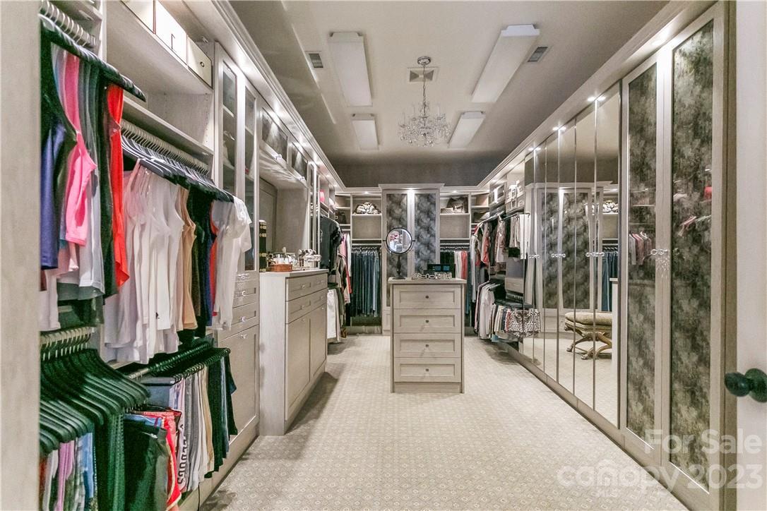 8371 Providence Road Charlotte, NC 28277 - Photo 39 of 48 a view of walk in closet with clothes and shoes