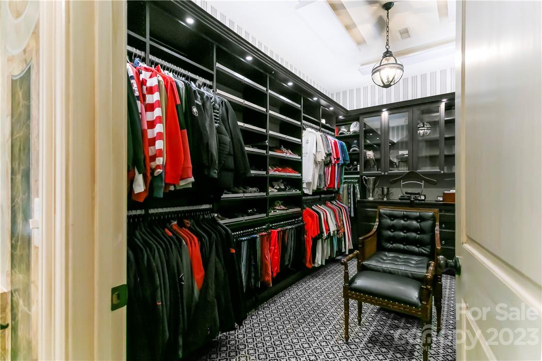 8371 Providence Road Charlotte, NC 28277 - Photo 42 of 48 a view of walk in closet with clothes and shoes