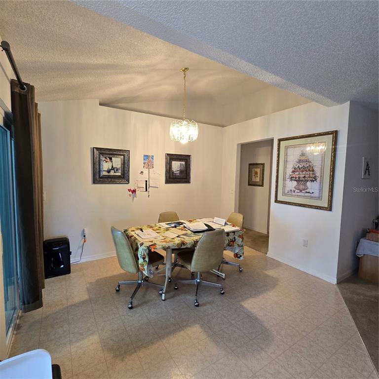 7280 Pinehurst Drive Spring Hill, FL 34606 - Photo 12 of 26 a dining room with a table and chairs
