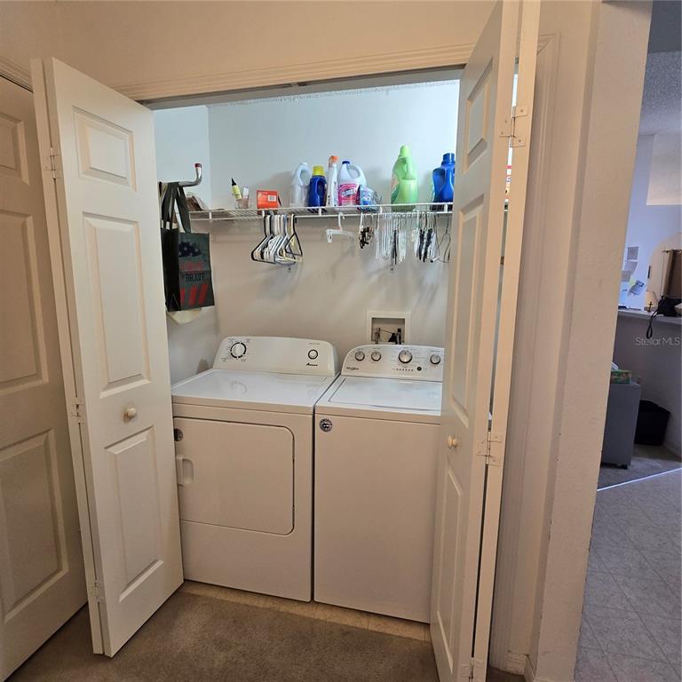 7280 Pinehurst Drive Spring Hill, FL 34606 - Photo 16 of 26 a utility room with dryer and washer