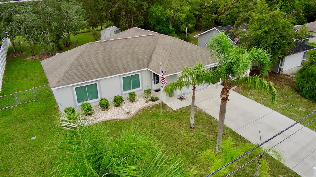 7280 Pinehurst Drive Spring Hill, FL 34606 - Photo 2 of 26 a house view with a garden space