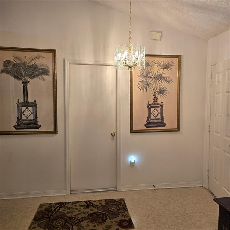 7280 Pinehurst Drive Spring Hill, FL 34606 - Photo 5 of 26 a view of a chandelier fan and wooden floor