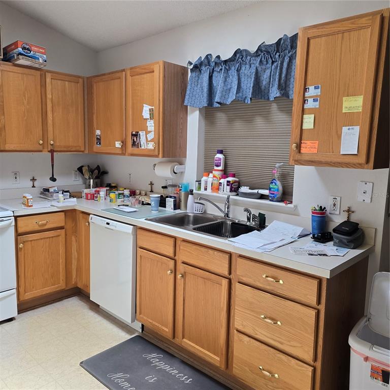 7280 Pinehurst Drive Spring Hill, FL 34606 - Photo 8 of 26 a kitchen with a sink dishwasher stove and cabinets