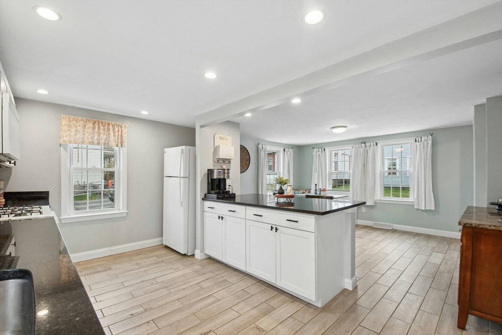 5 Elm Street Northbridge, MA 01588 - Photo 12 of 23 a kitchen with stainless steel appliances granite countertop a stove top oven a sink dishwasher and a refrigerator with wooden floor