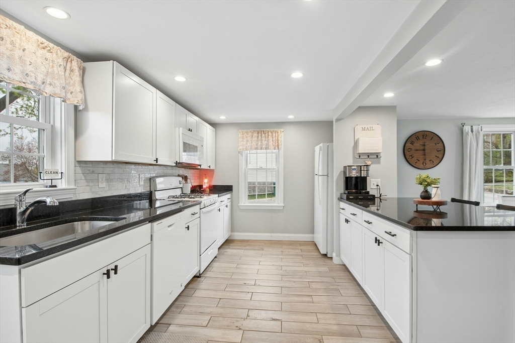 5 Elm Street Northbridge, MA 01588 - Photo 3 of 23 a large kitchen with stainless steel appliances granite countertop a sink and dishwasher a stove top oven with wooden floor