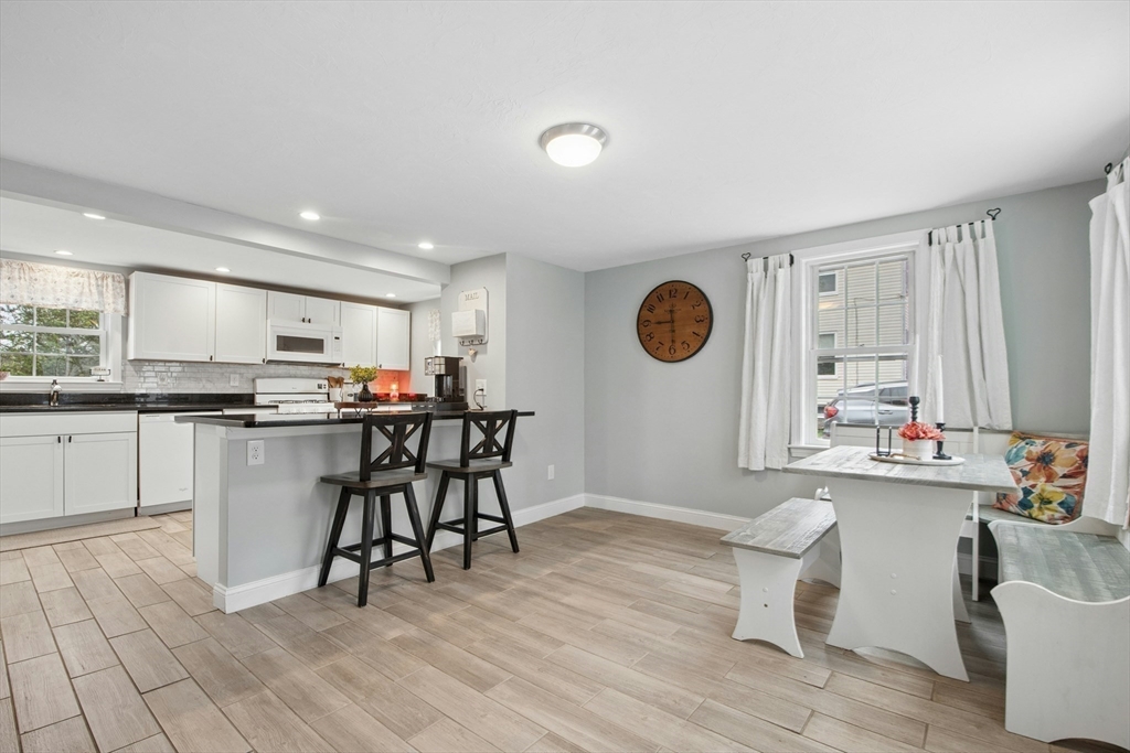 5 Elm Street Northbridge, MA 01588 - Photo 4 of 23 a kitchen with a table chairs refrigerator and microwave