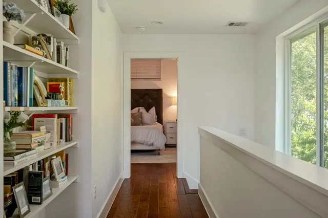 a bedroom with a bed and a book shelf