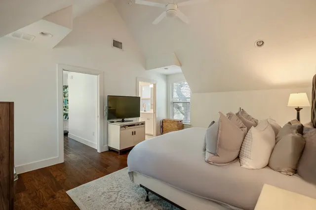 a bedroom with a bed and a flat screen television