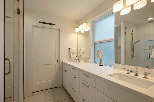 a bathroom with a double vanity sink mirror and double