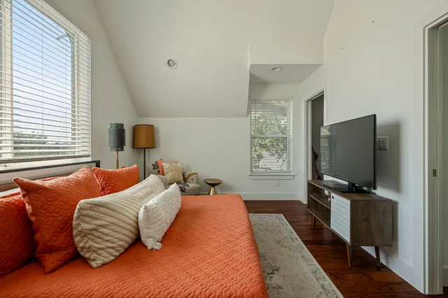 a bedroom with two beds and a flat screen tv