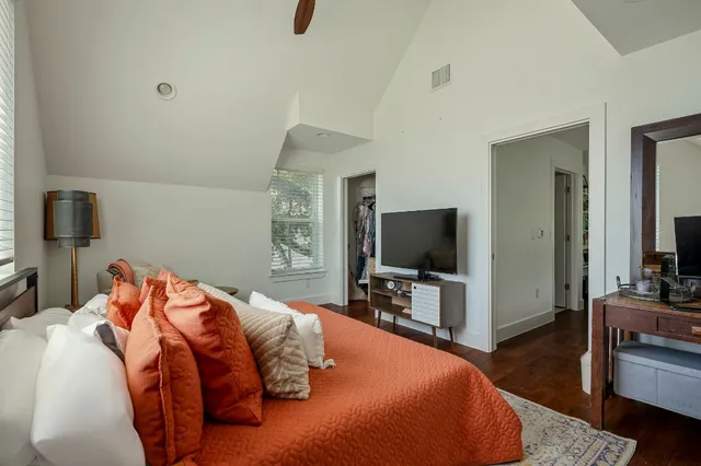 a bedroom with a bed and a flat screen tv