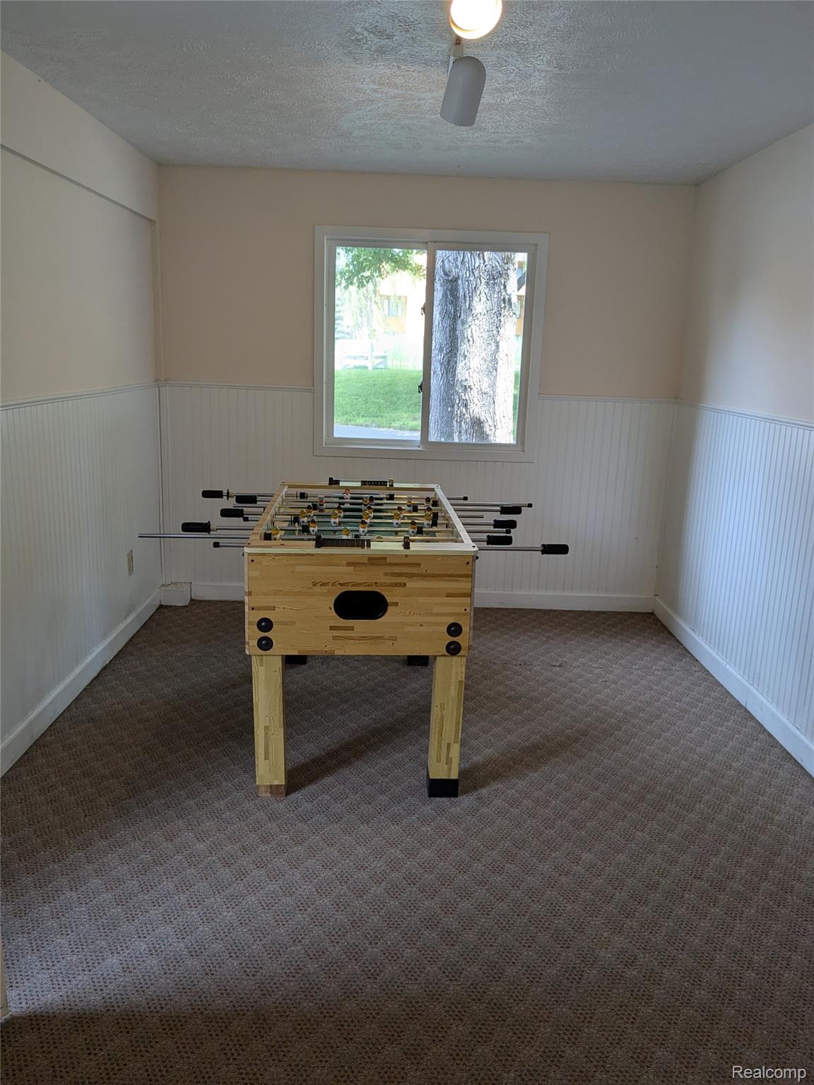 4749 South Pleasantview Road, Unit 37 Harbor Springs, MI 49740 - Photo 37 of 44 Game Room Near North Entrance with Foosball Table for Guests to Use