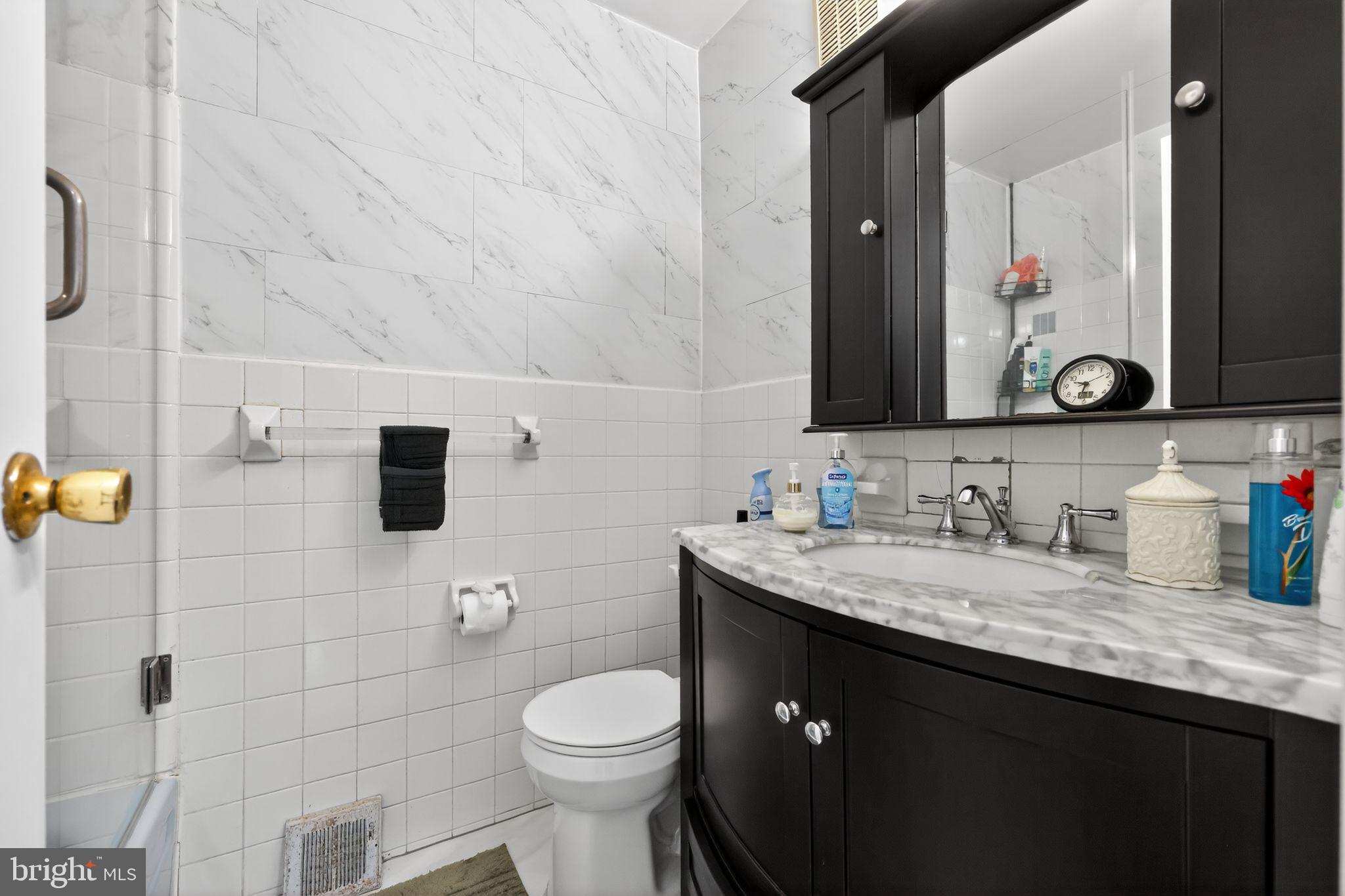 9766 Hilspach Street Philadelphia, PA 19115 - Photo 14 of 30 a bathroom with a granite countertop toilet sink a mirror and shower