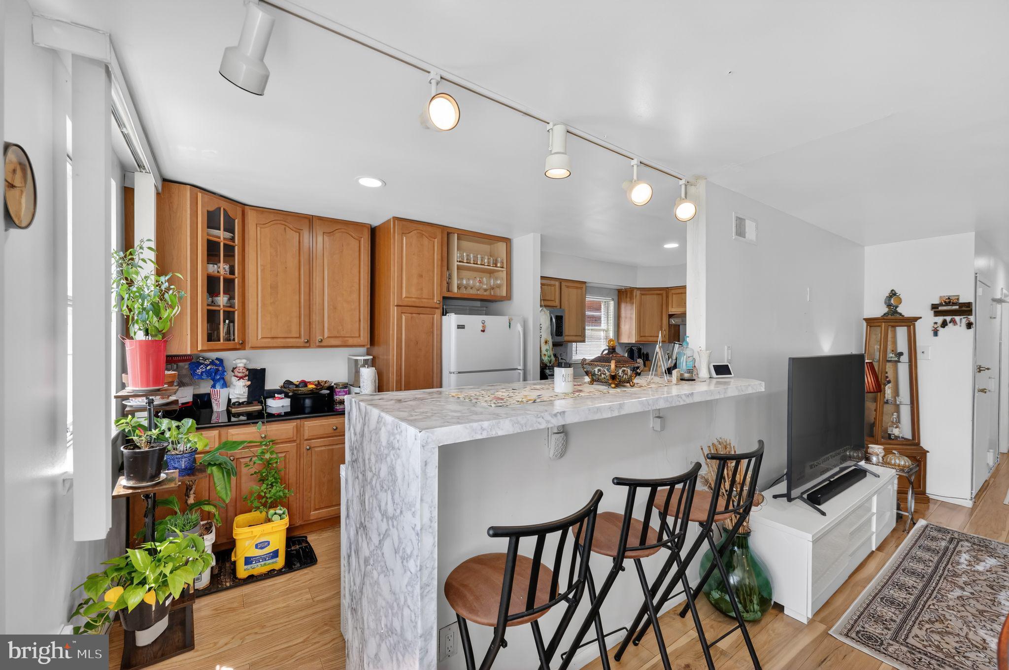 9766 Hilspach Street Philadelphia, PA 19115 - Photo 6 of 30 a kitchen with a table chairs refrigerator and microwave