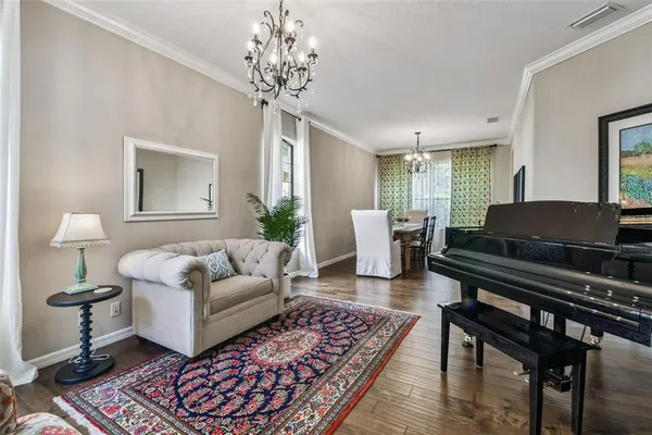 a dining room with furniture a chandelier and window