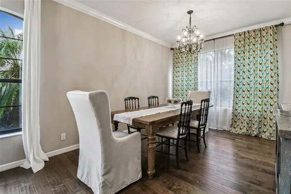 a dining room with a wooden table and chairs