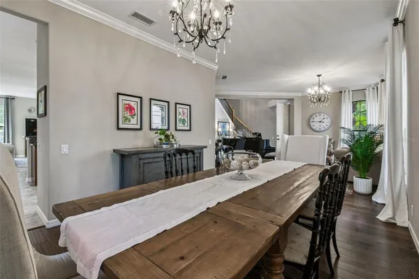 a living room with furniture a large window and a table