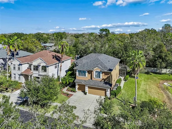 an aerial view of a house with a yard