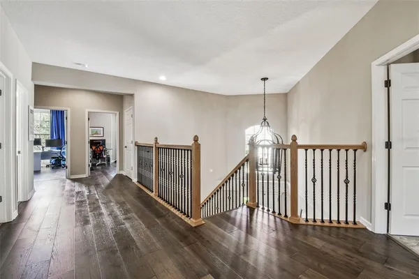 an aerial view of residential houses with outdoor space and trees