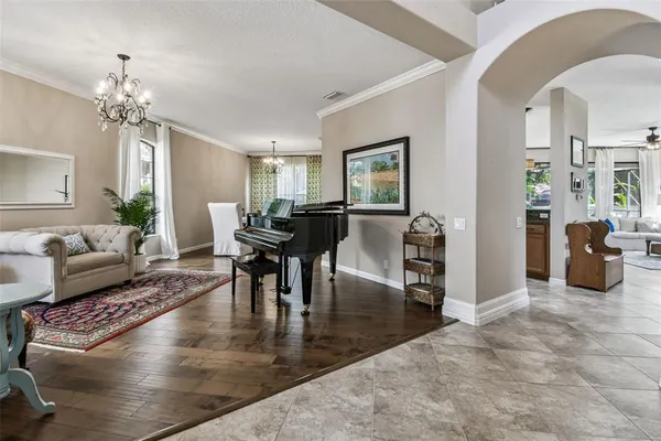 a living room with fireplace furniture and a chandelier