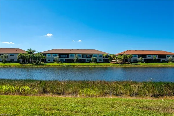 a view of a lake with houses in the background