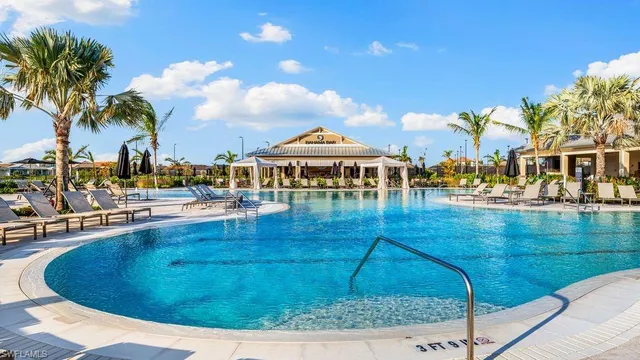 a view of a swimming pool with outdoor seating