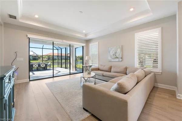 a living room with furniture and a large window with outer view