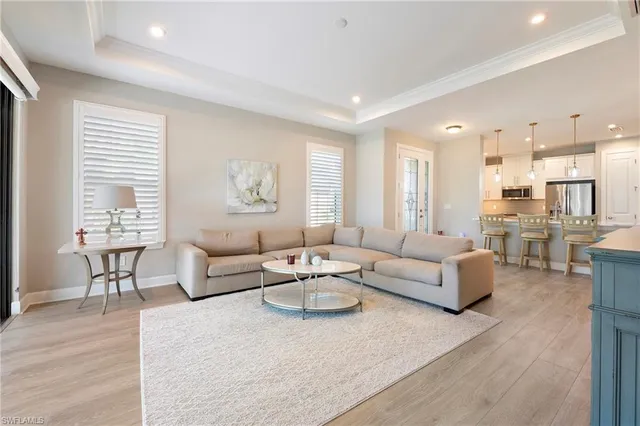 a living room with furniture and view of kitchen