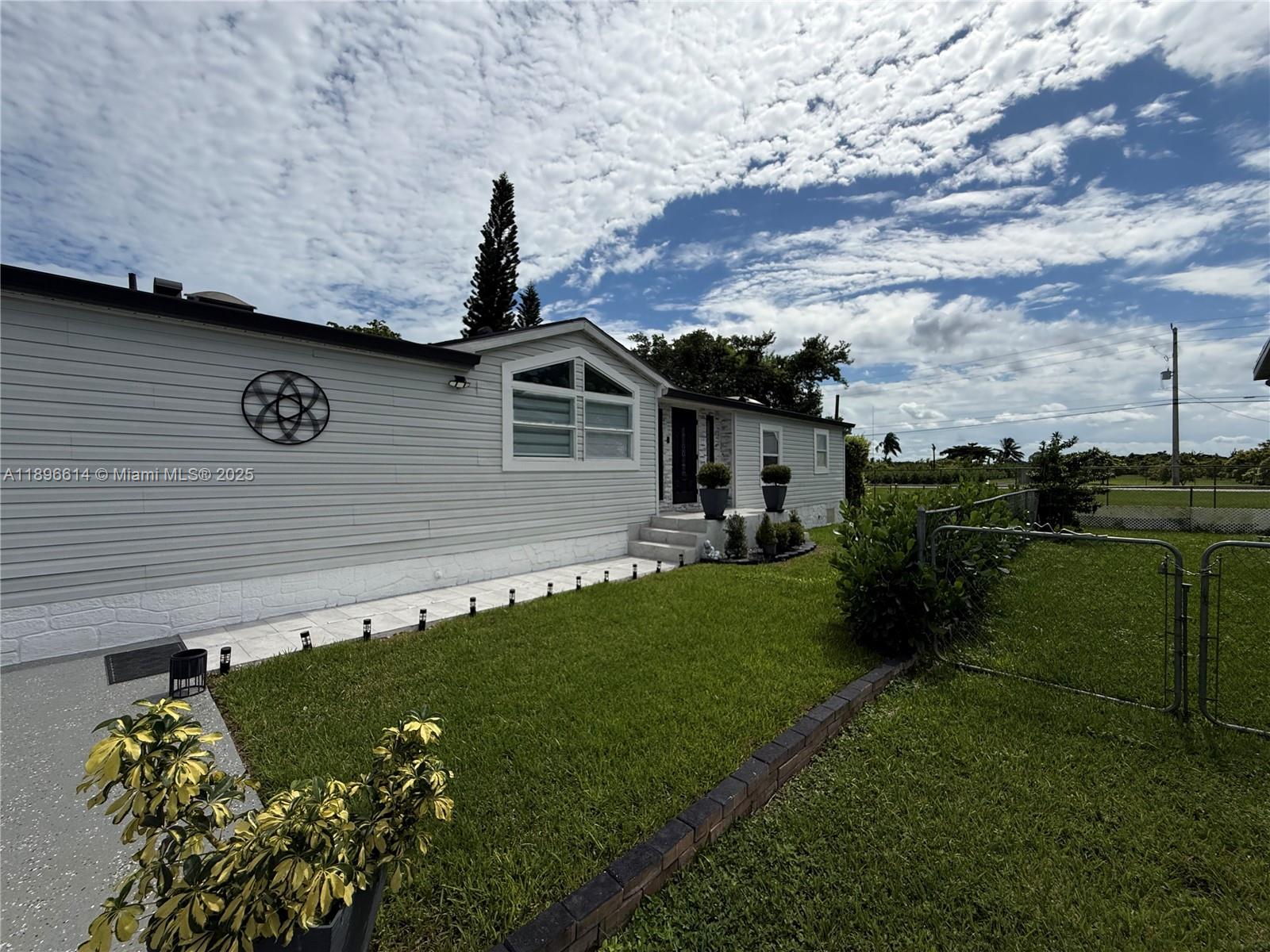 19800 Southwest 180th Avenue, Unit 154 Miami, FL 33187 - Photo 3 of 9 a backyard of a house with lots of green space
